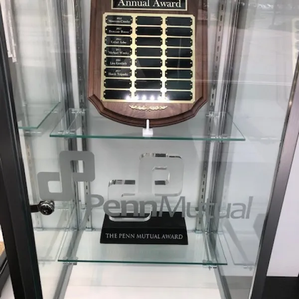 Penn Mutual recognition plaque displayed in a glass case