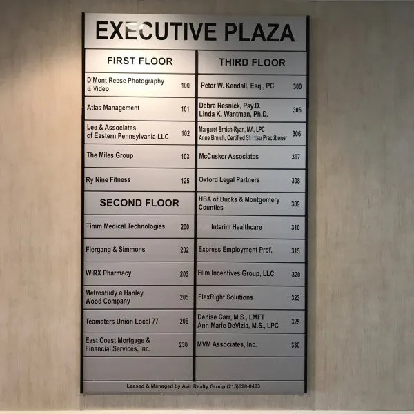 Executive Plaza interior tenant directory mounted on a wall