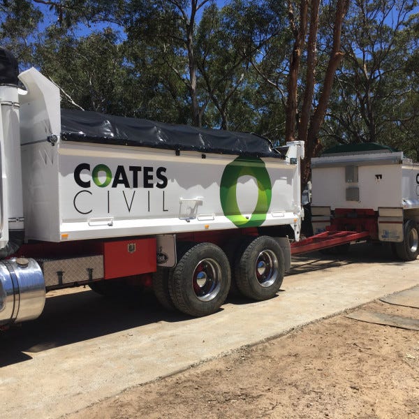 Truck Graphic. White truck with black and green branding and logo