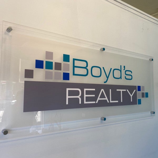 Boyd's Realty - acrylic reception sign with vinyl lettering finished with stainless steel stand offs - Signarama Sydney CBD South
