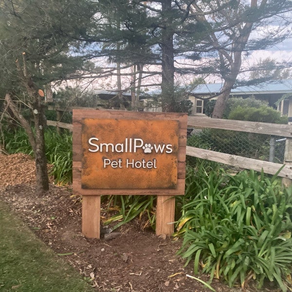 Small Paws Pet Hotel_Custom wood and metal lettering post and panel sign with rust finish face