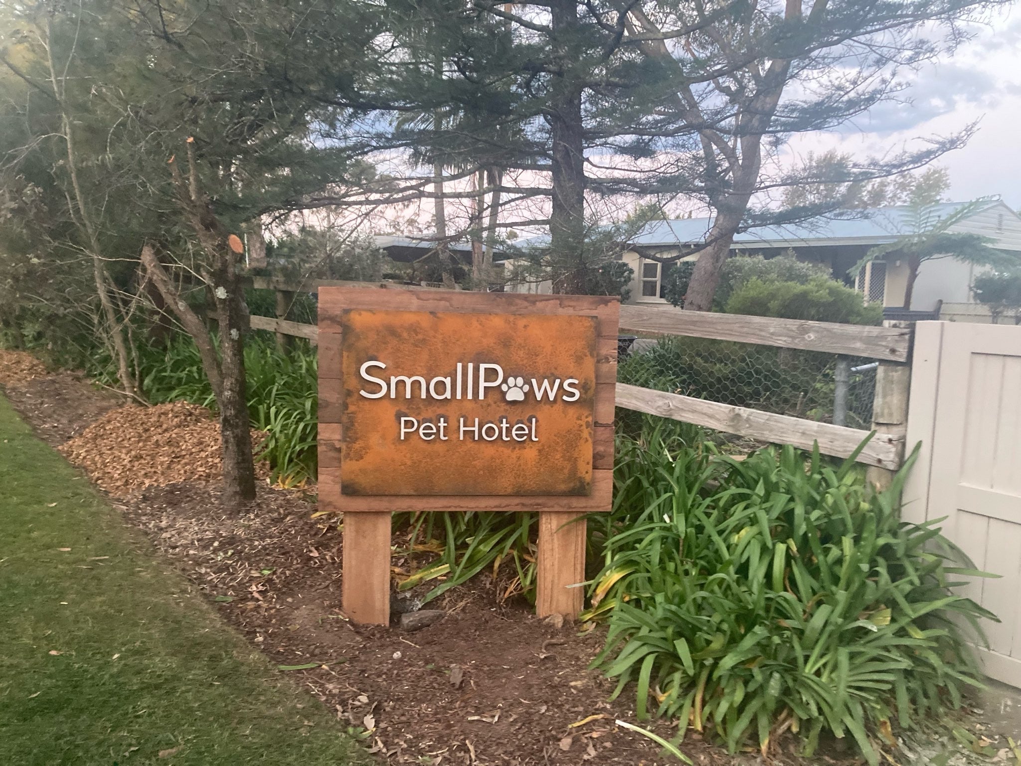 Small Paws Pet Hotel_Custom wood and metal lettering post and panel sign with rust finish face