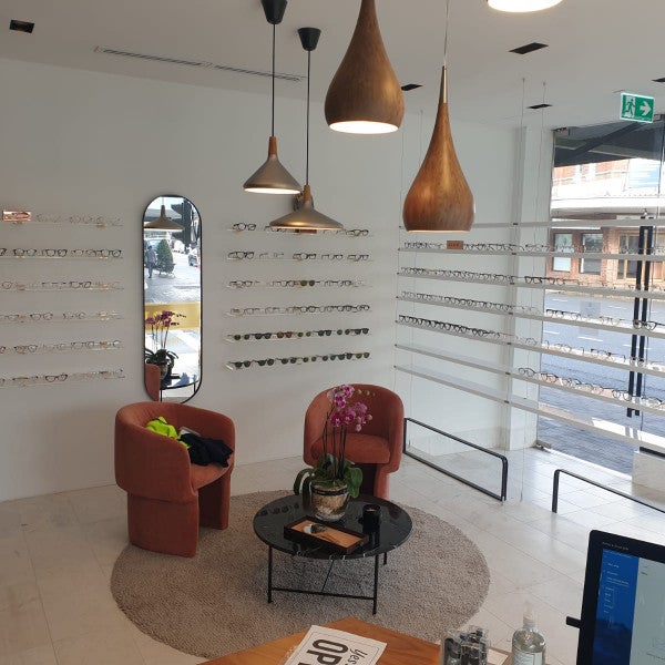 Core Optique Mosman_10mm clear acrylic custom shelving with suspension cables and clear acrylic wall shelves