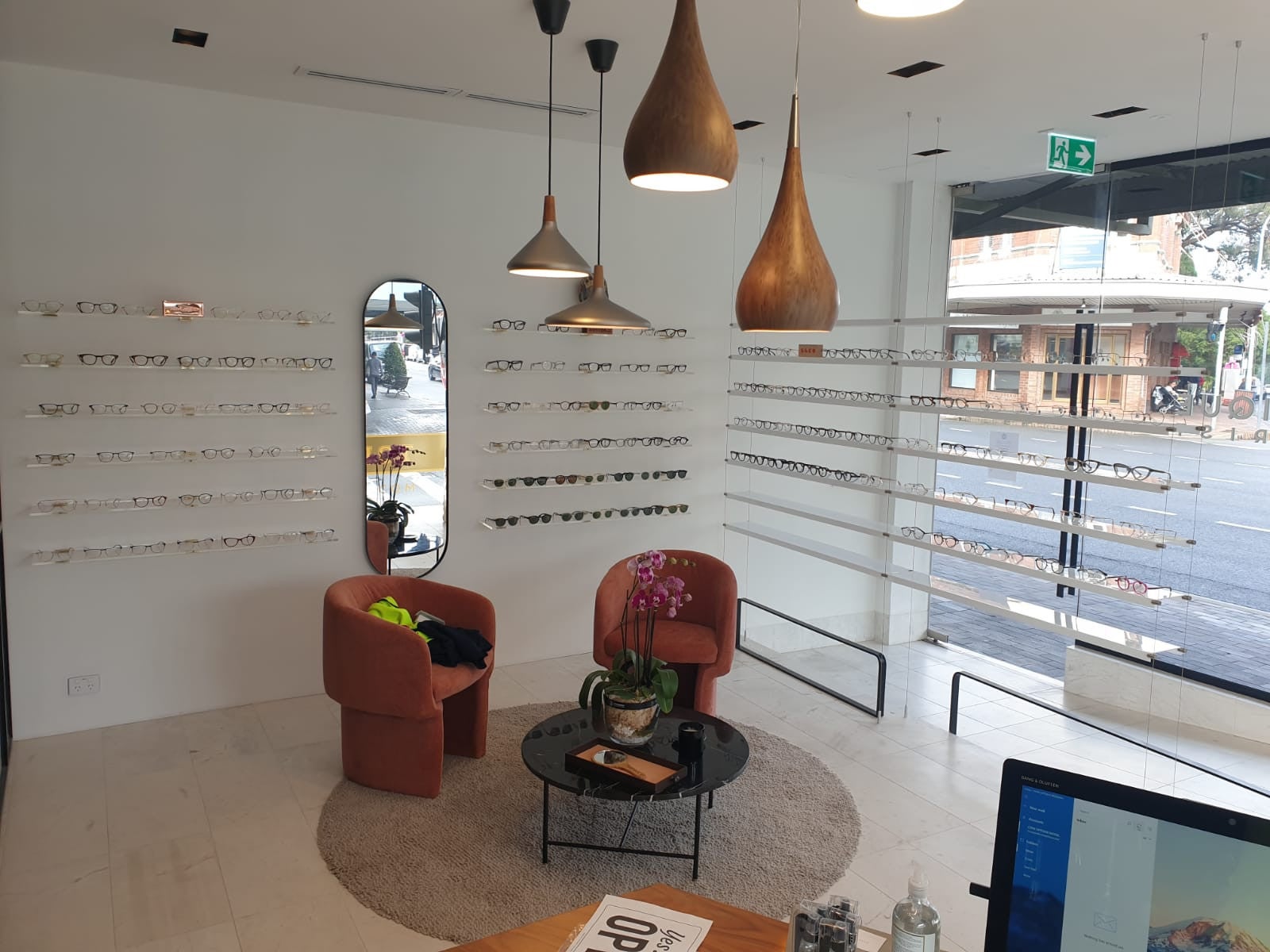 Core Optique Mosman_10mm clear acrylic custom shelving with suspension cables and clear acrylic wall shelves