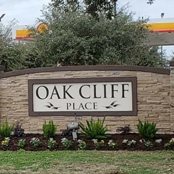 Monument W/ Engraved Letters At Oak Cliff Place - Houston, TX