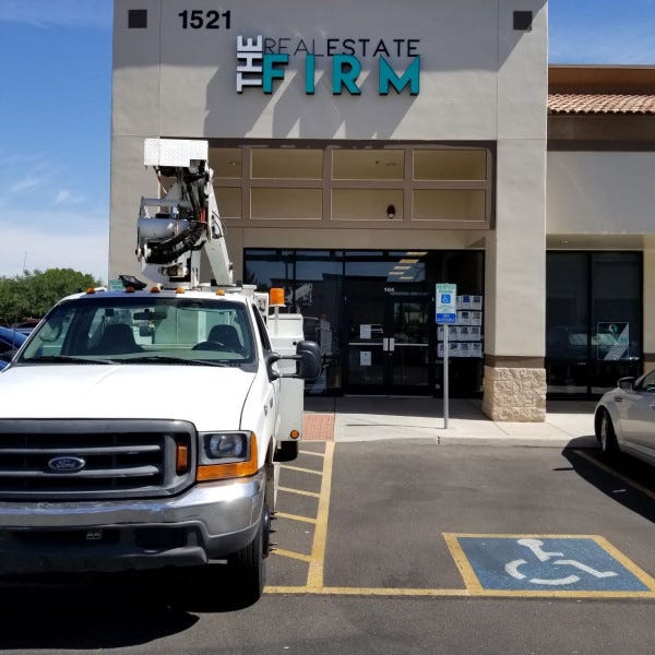 Building Sign- The Real Estate Firm