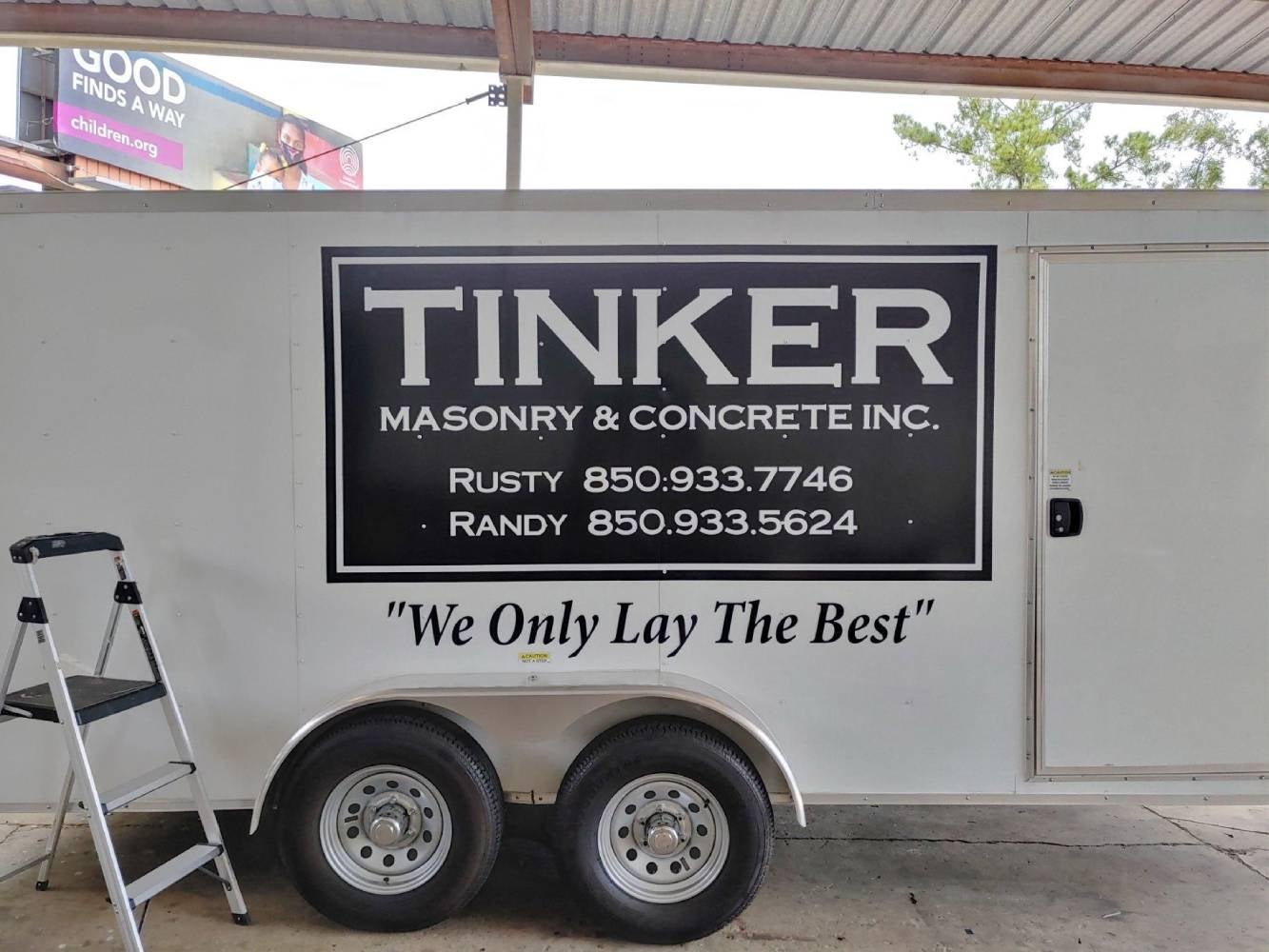 Commercial trailer graphics displaying Tinker Masonry and Concrete Inc. branding and contact details