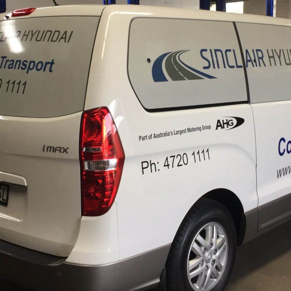 Vehicle One Way Vision for courtesy transport van. White one way vision windows with branded text