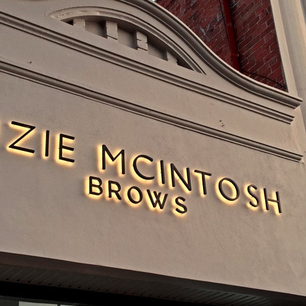 3D Illuminated Letters black with gold halo lighting on stone