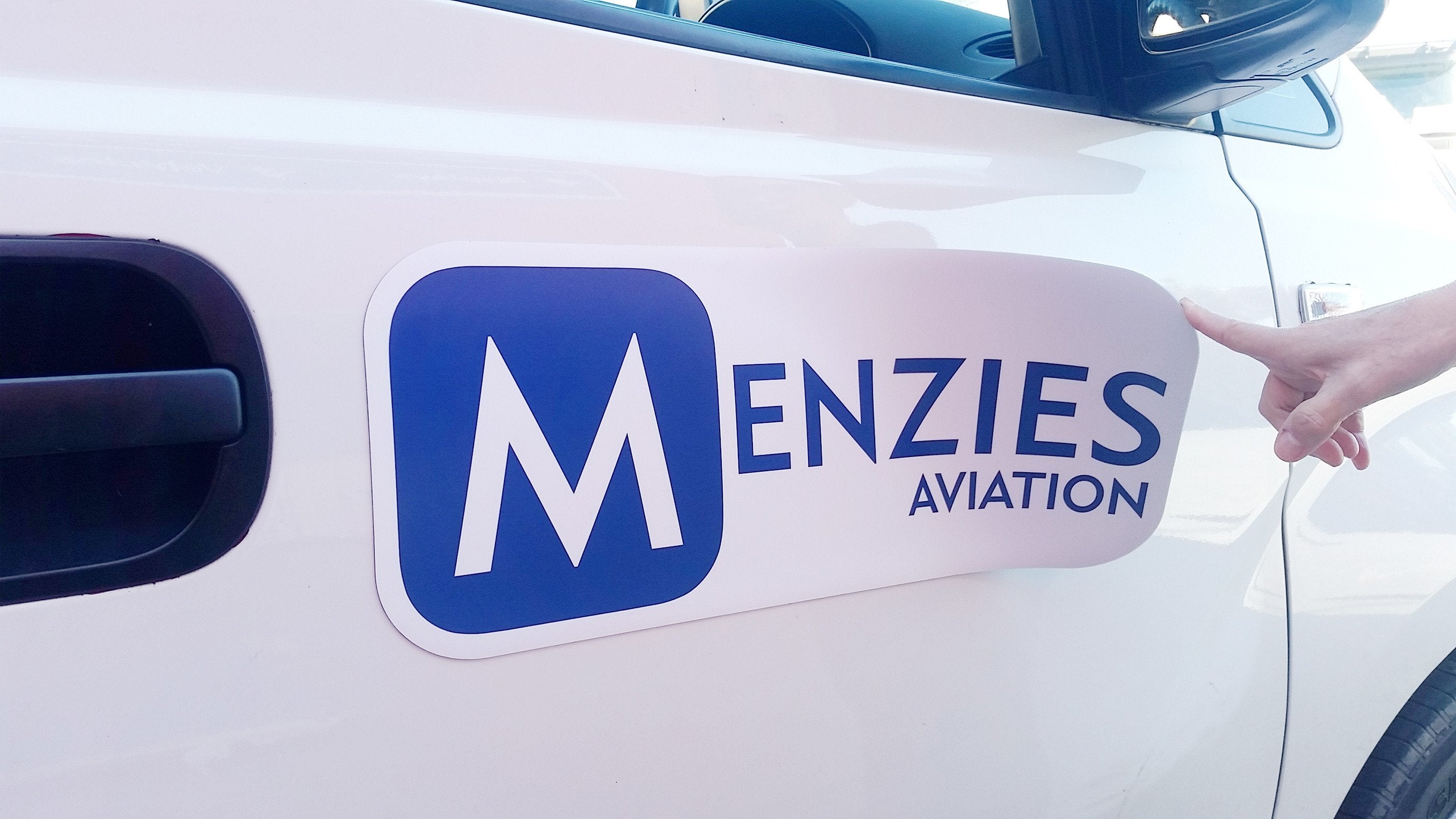 Magnetic Vehicle Sign branded with blue and white graphics and logo