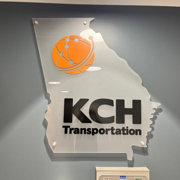 Acrylic wall sign shaped like Georgia with KCH Transportation logo