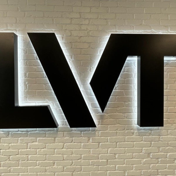 Interior Halo Illuminated Channel Letters • Dimensional Logo Medallion • Large Wall Murals in American Fork for LVT (a Security Systems Company).