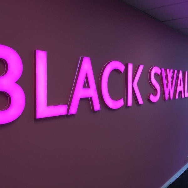 Bright illuminated signage with 3D letters in pink