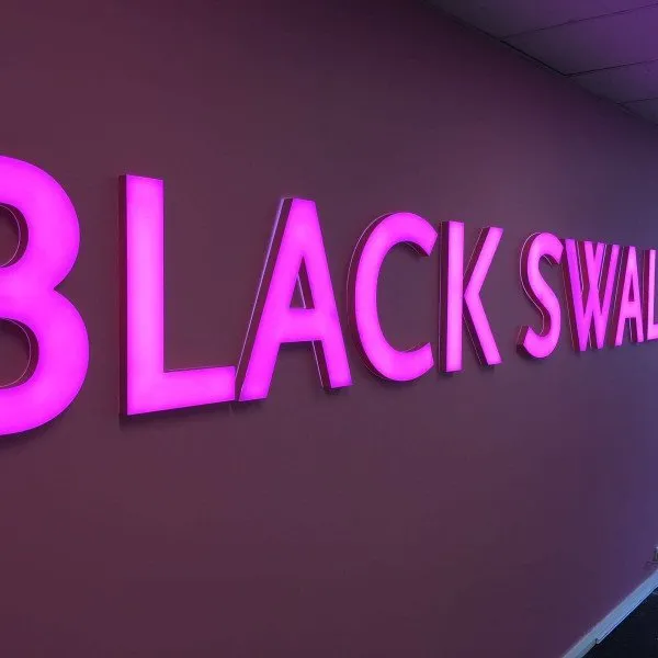 Bright illuminated signage with 3D letters in pink