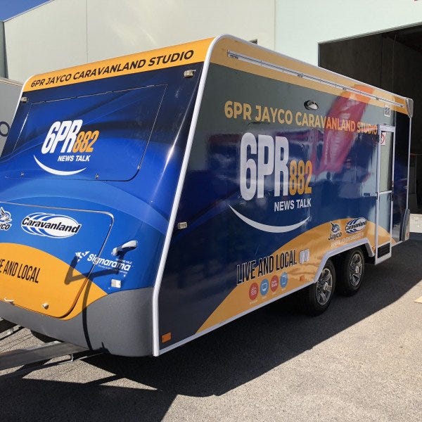 Trailer Sign for a caravan to promote a news radio show. The branding is blue and orange