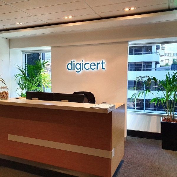 Reception sign black letters with white halo lighting on plain wall