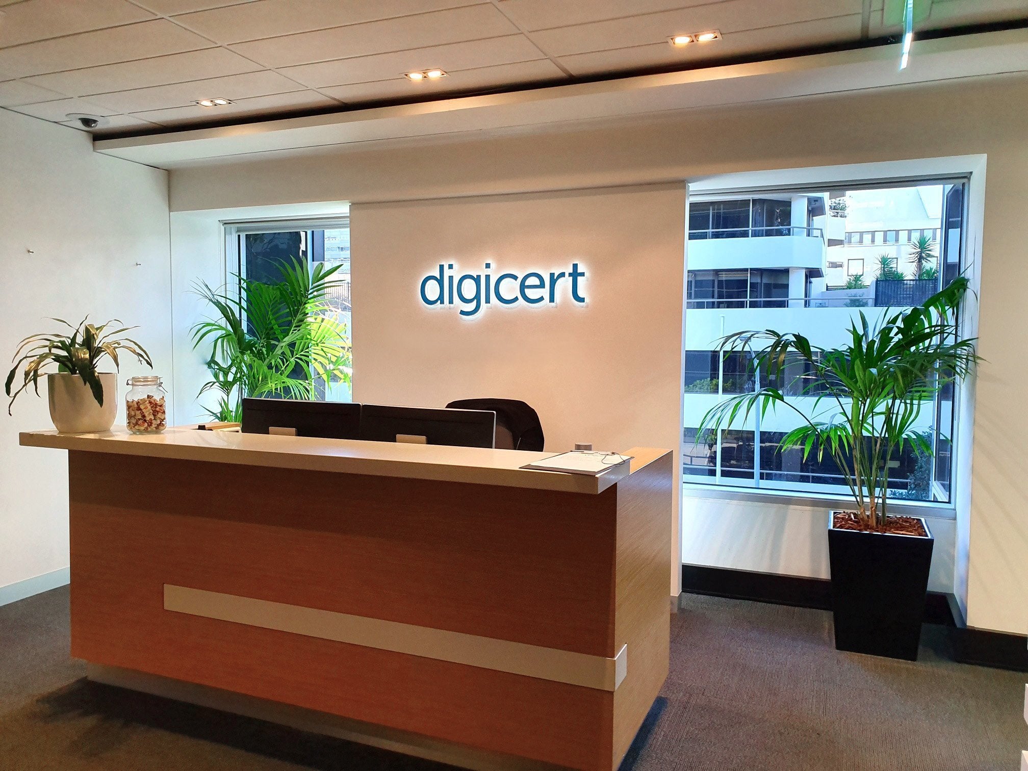 Reception sign black letters with white halo lighting on plain wall