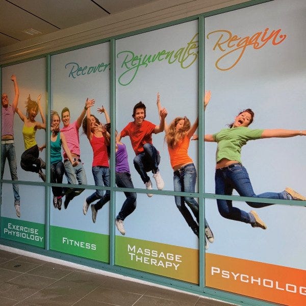 Window Graphic for a health practice with image of multiple people jumping in joy