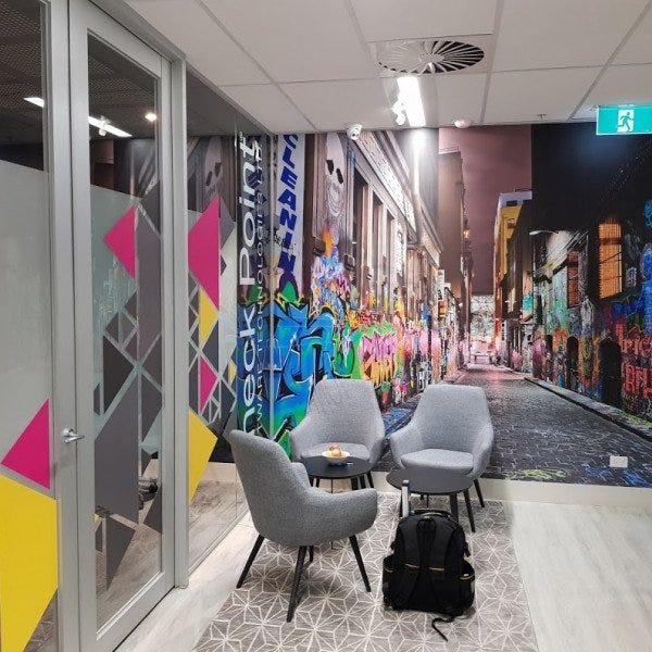 Window and wall graphics in office waiting area with bright and colourful artwork