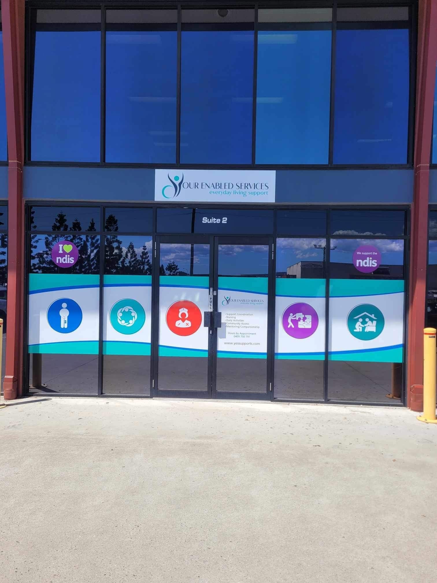 YES! Vibrant Window Graphics and New Building Sign Make Your Enabled Services Standout
