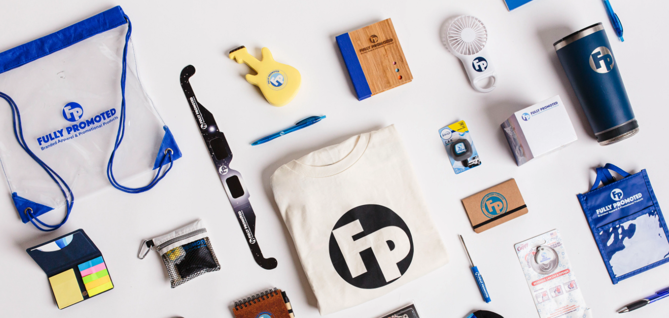 Various Fully Promoted branded products including a t-shirt, a clear backpack, a water bottle, and a hand held fan are placed next to each other against a white background. 
