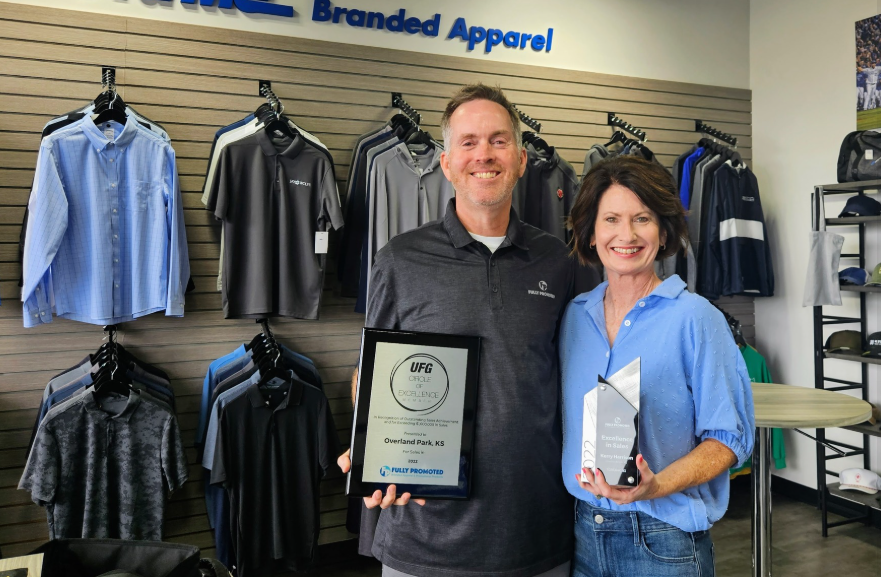 Image of Jeff Moffett, Owner of Fully Promoted, Oakland Park, KS in his showroom with an award